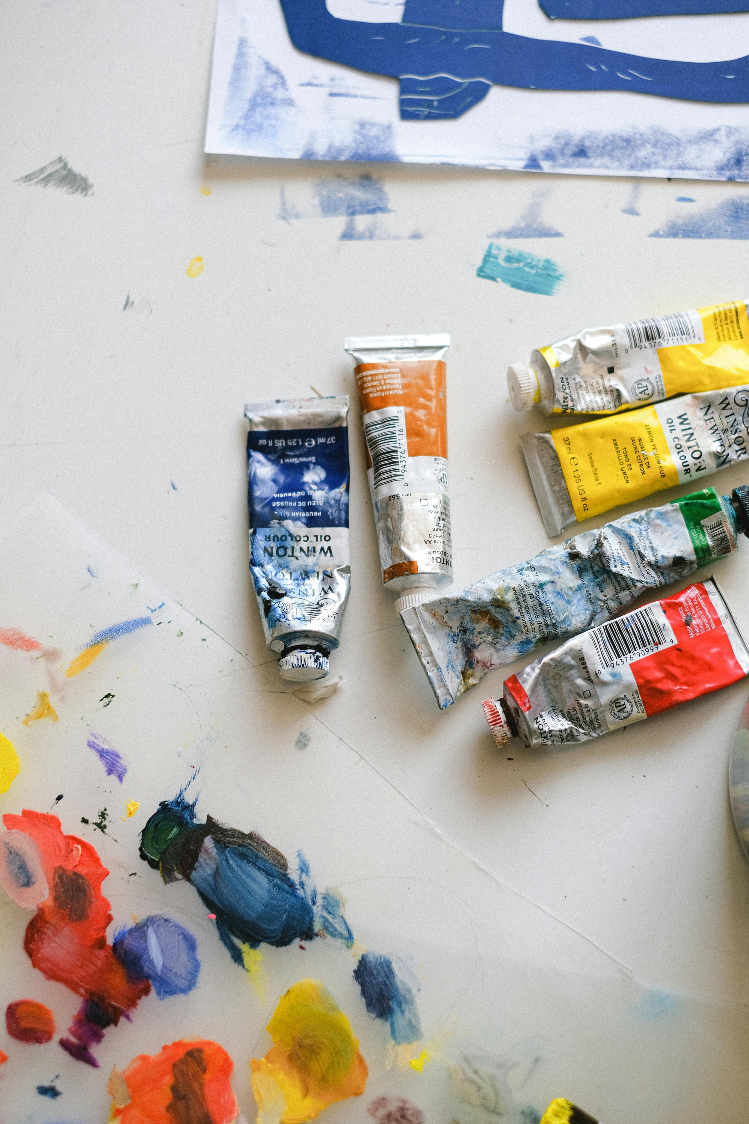 Picture of multicoloured paints on a messy table